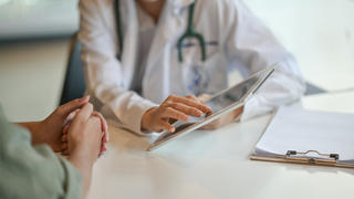 Doctor speaking to patient in consultation