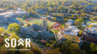 Aerial view of Saint Joseph's University campus with Philadelphia skyline in the background