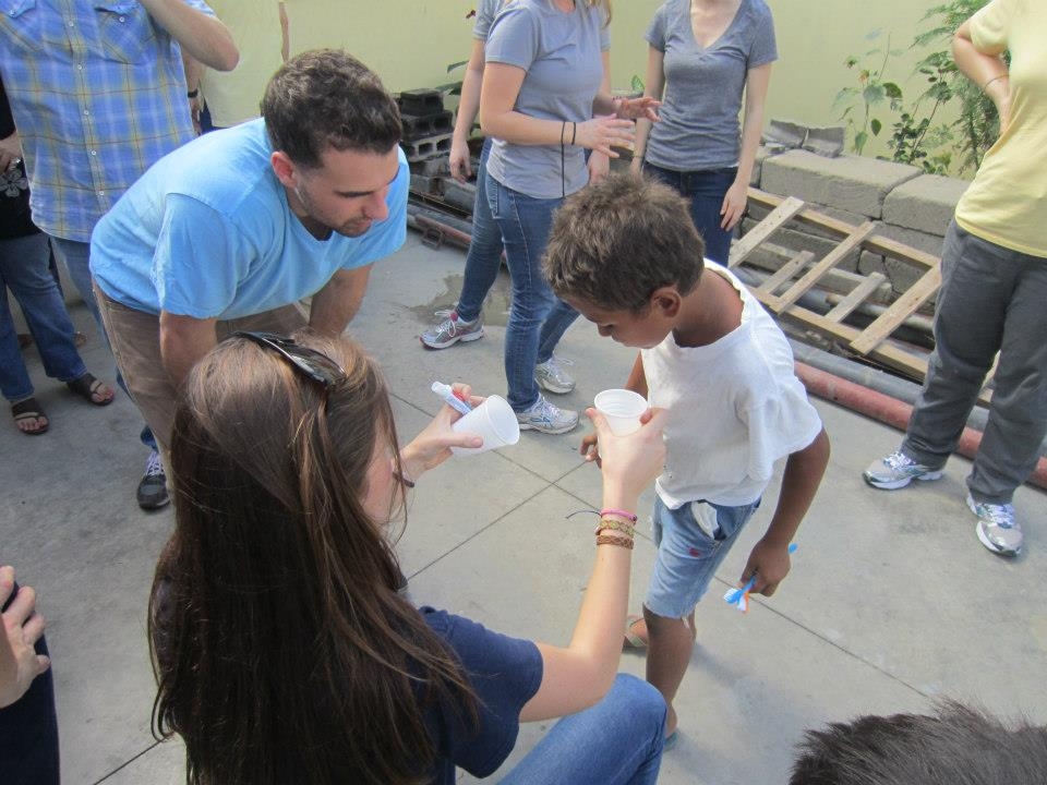 Students work with a child from Nicaragua