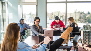 Students hanging out in common area in dorm at Saint Joseph's University