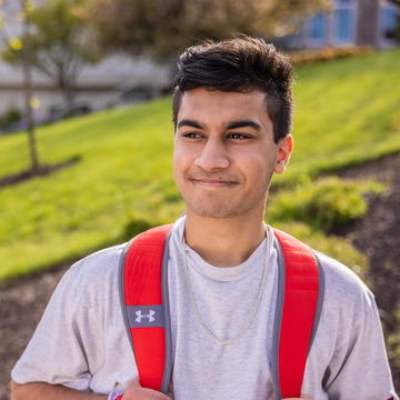 Saint Joseph's University student looking at campus on a sunny day.