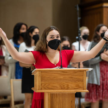 Student raising hands in worship