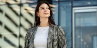 Female student standing outside looking up