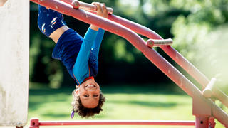 Child plays on jungle gym at Camp Kinney