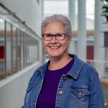 Betsy outside of a classroom