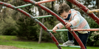 Child with autism plays on jungle gym