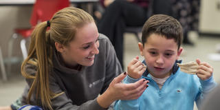 Teacher and student play with clay