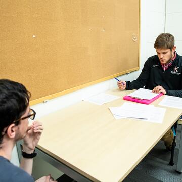 two scholars doing an interview
