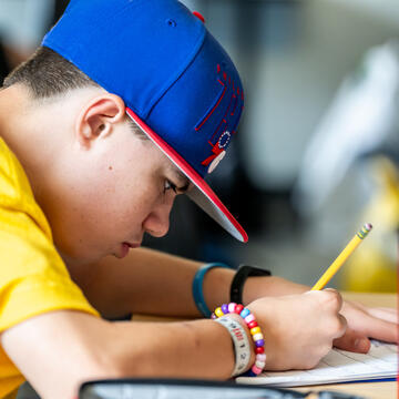 student writing on a paper