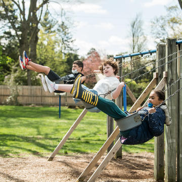 Children play on swing set