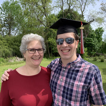 Betsy and a young man in a graduation cap