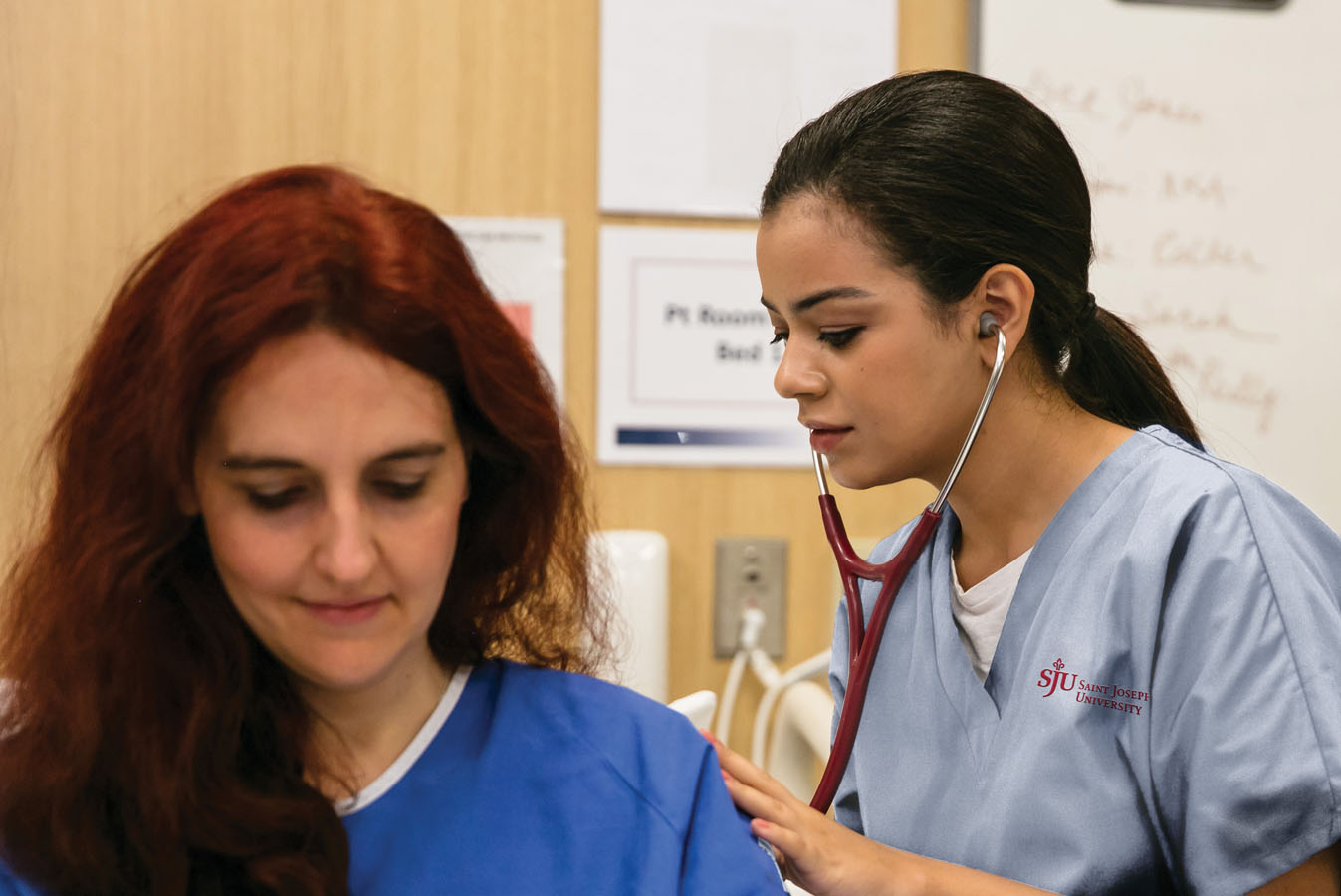 Saint Joseph's University nursing student working with a patient