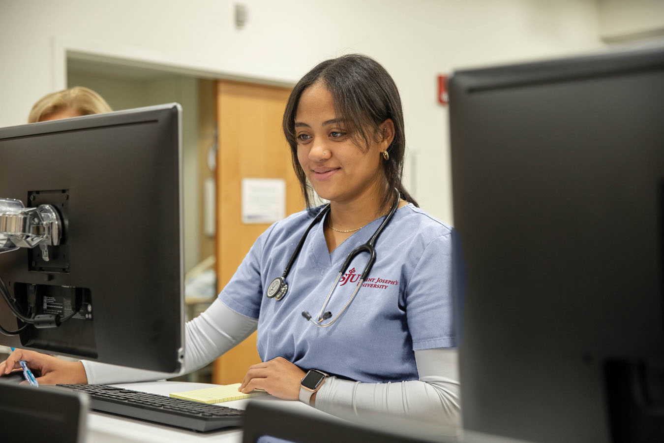 Saint Joseph's University nursing student at a desk