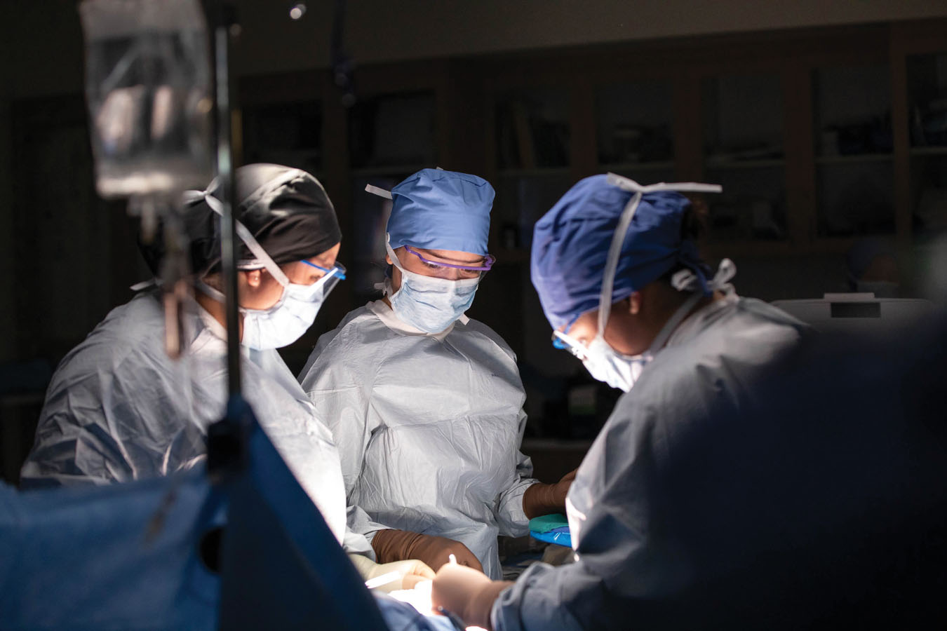 students and doctors in an operating room performing practice surgery