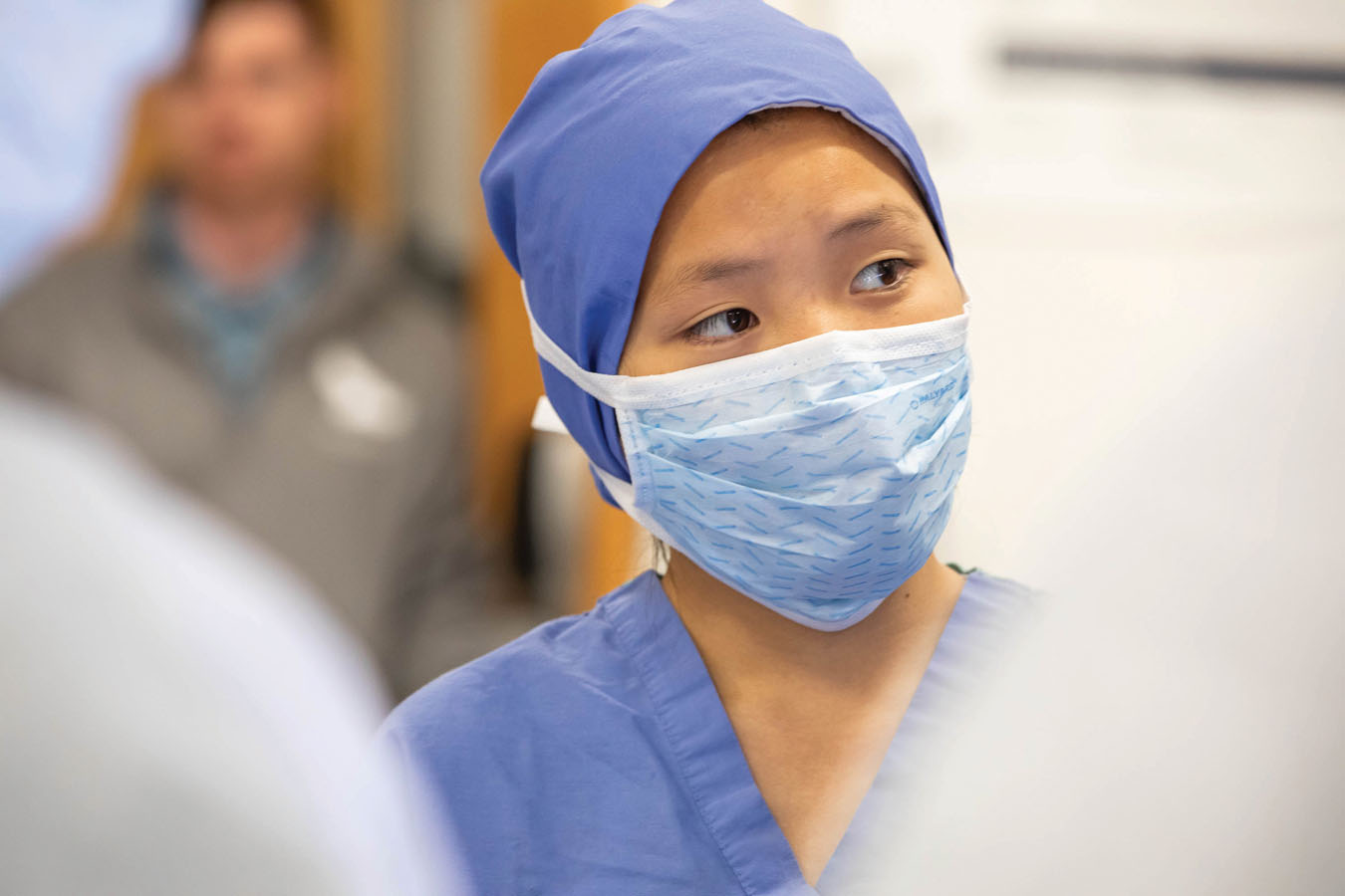 Saint Joseph's University student in an operating room with a mask on