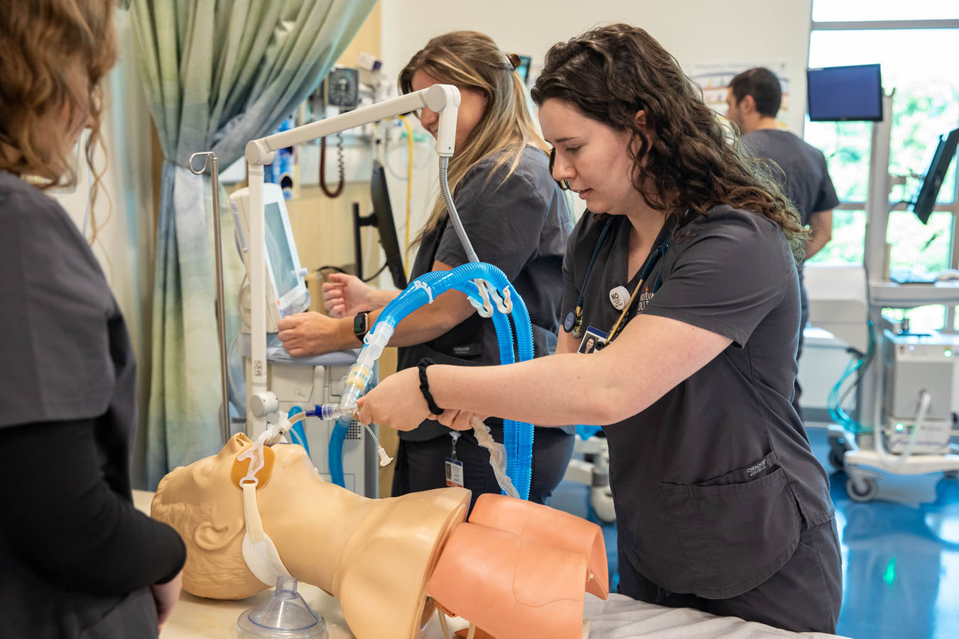 Two Saint Joseph's University students practicing on a simulation patient