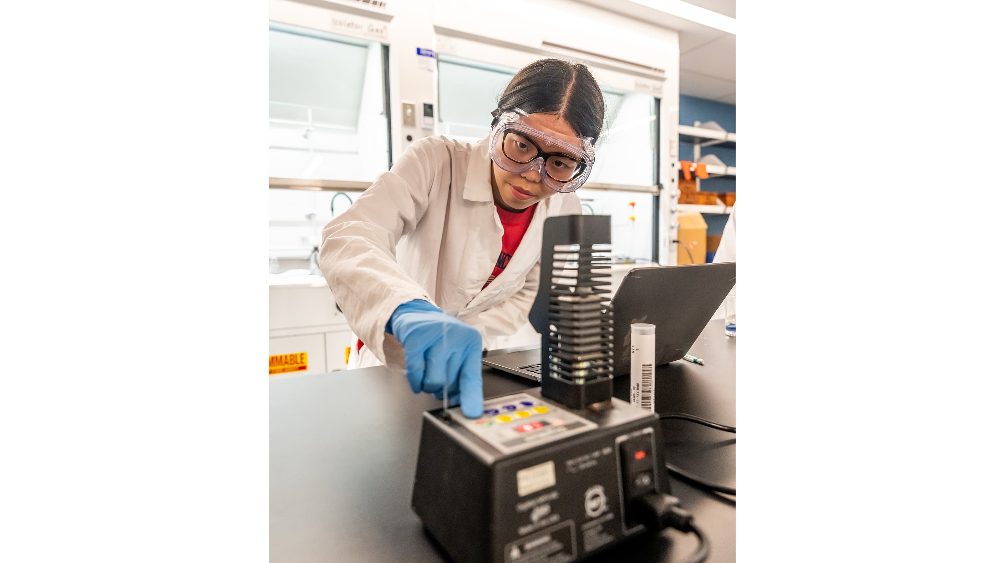 Female pharmaceutical science and healthcare major, working in the organic chemistry lab on a melting point apparatus.