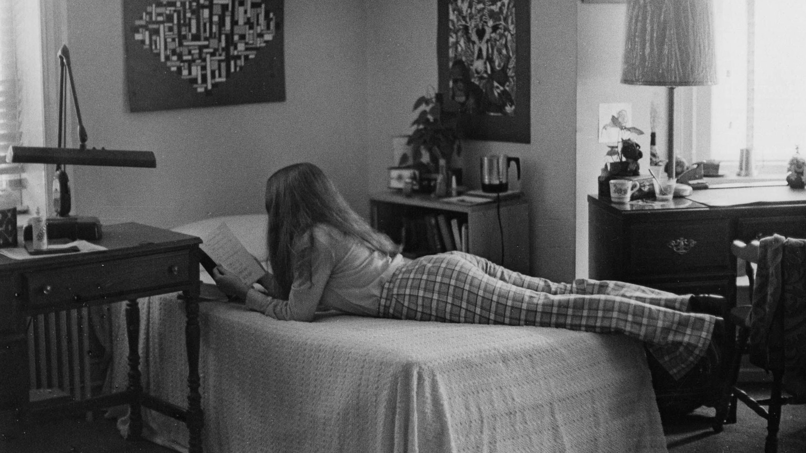 A female student is studying in her residence