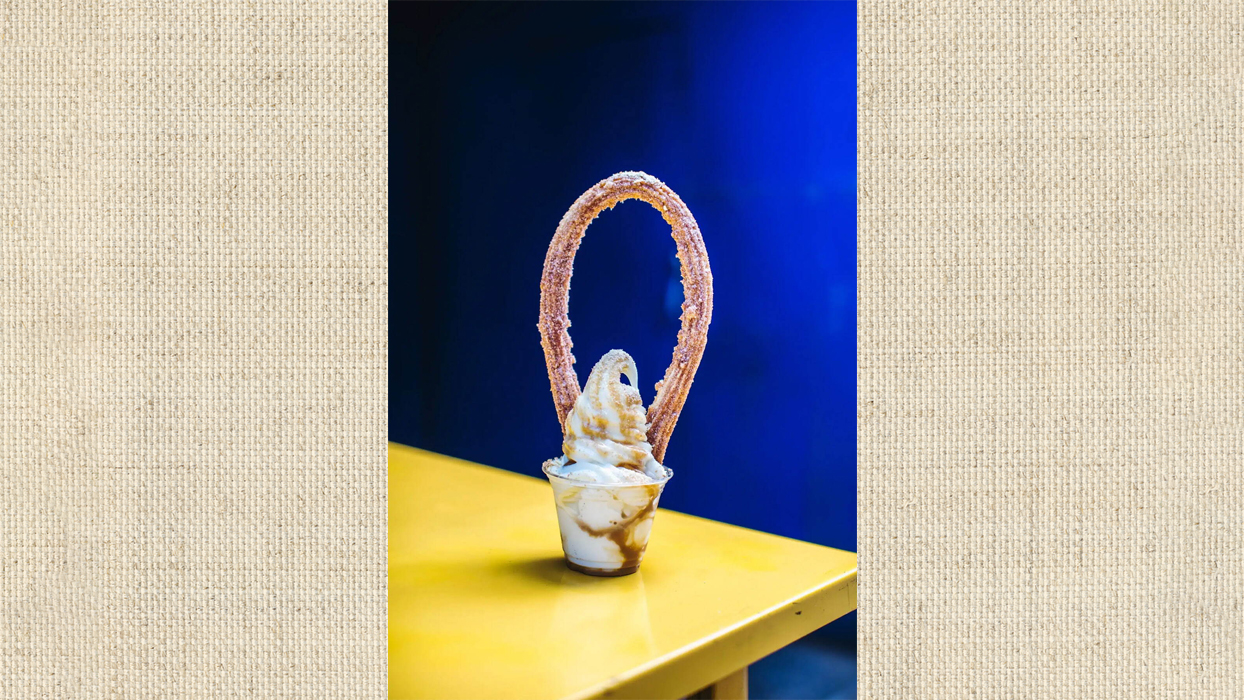 foot-long churro on top of vanilla ice cream