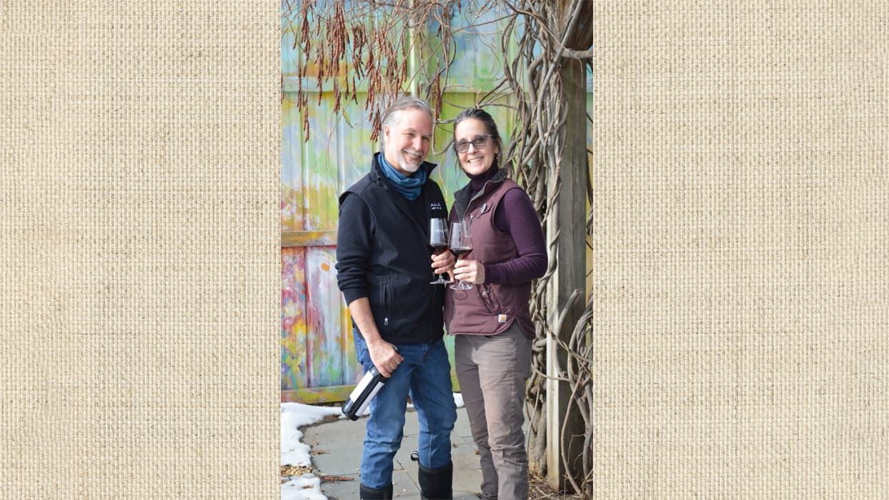 Male and Female taking photo together in winery holding a wine bottle