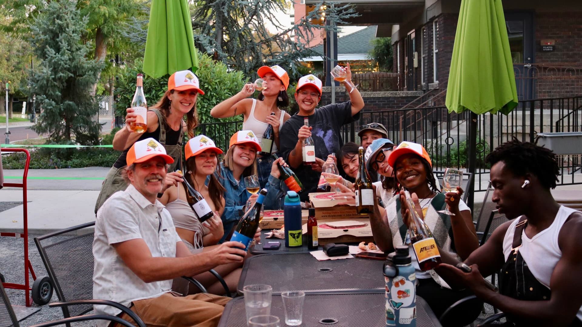Staff members drinking wine together outside