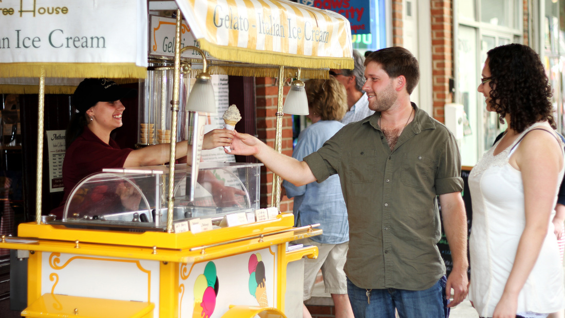 two people buying gelato from a gelato cart