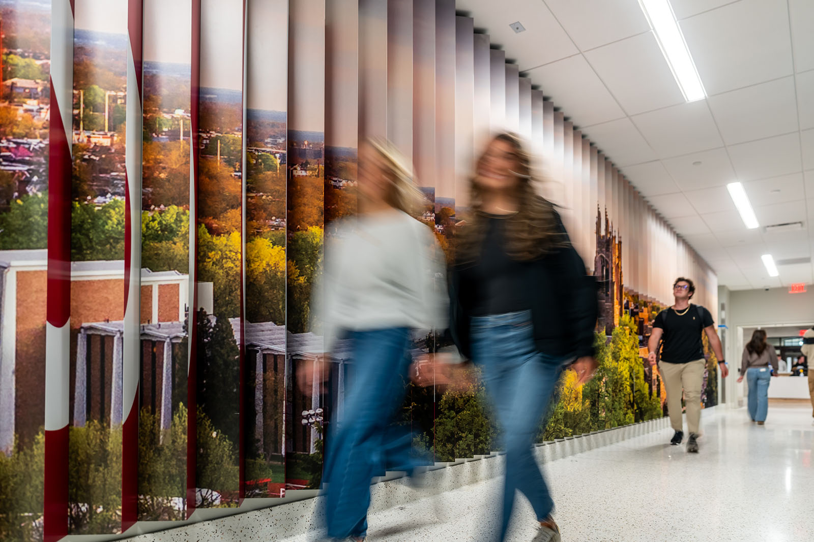 A blur of students walking down a modern hallway
