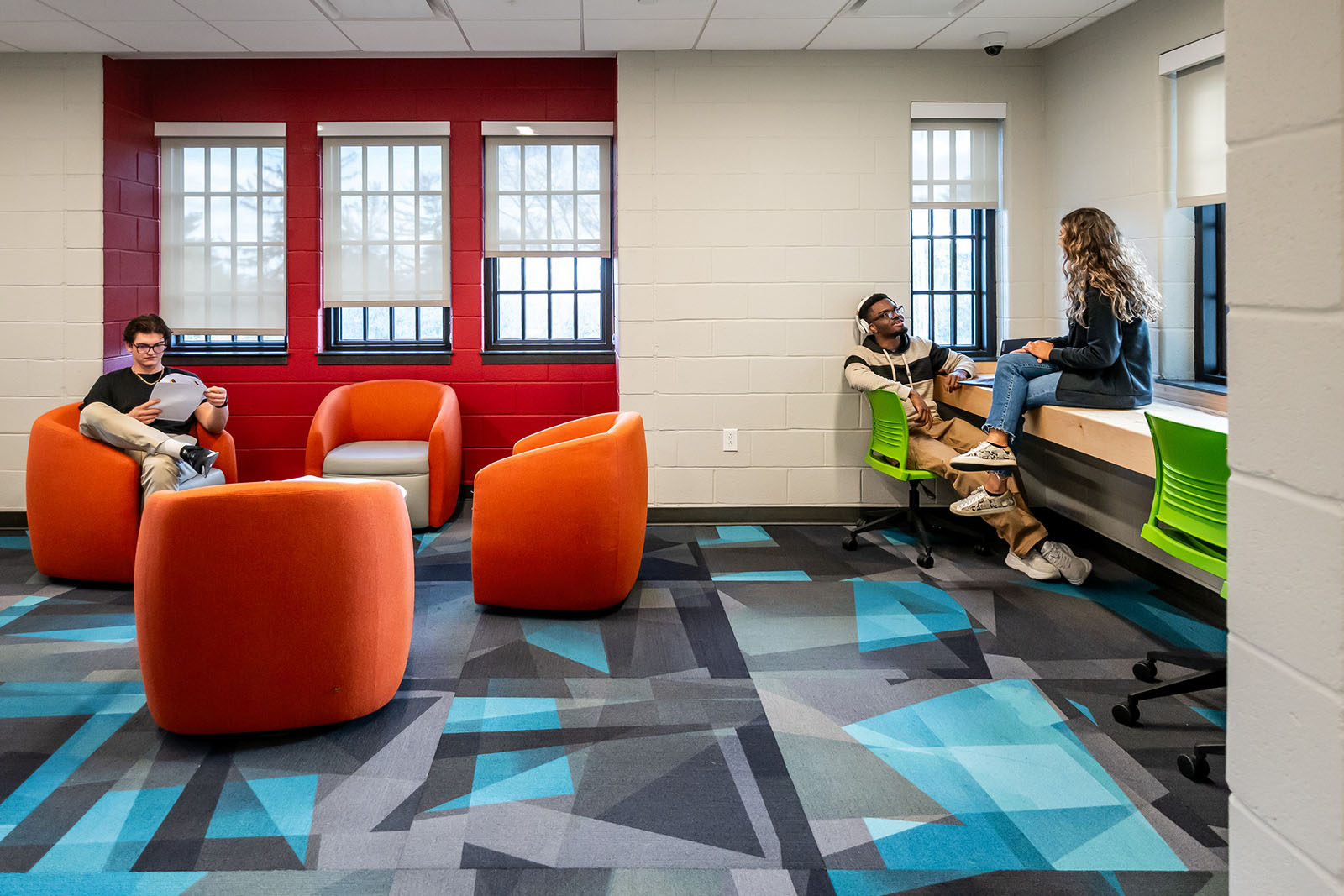Orange chairs sitting on a blue grey carpet