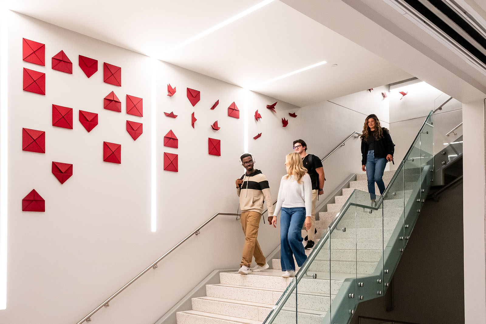 Students walking down a brightly lit staircase