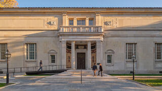 A large stone building with an ornate door and windows