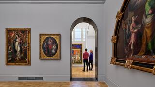 Inside the Frances M. Maguire Art Museum showing a gallery with artwork on the walls