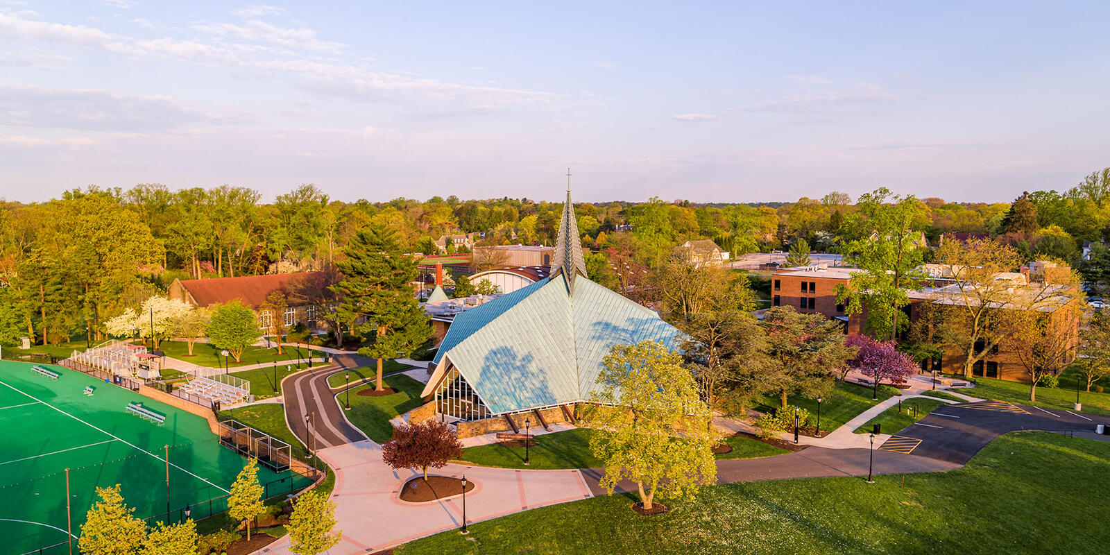 A large chapel with a green spire on Hawk Hill campus