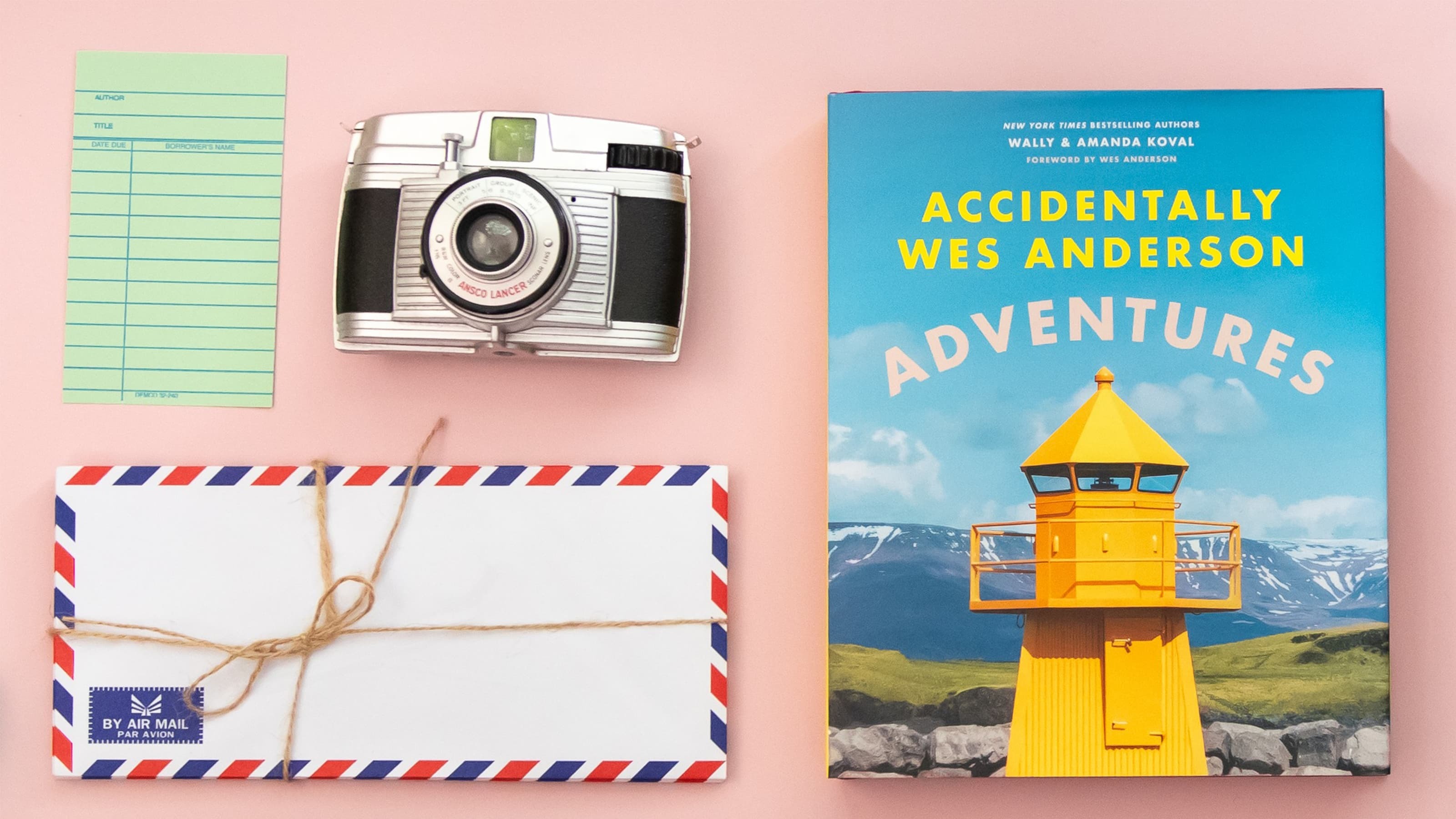 Accidentally Wes Anderson coffee table book with a camera, menu and envelope.
