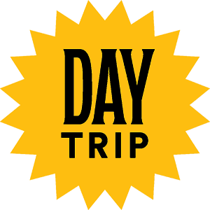 yellow badge with "Day Trip" written in black letters