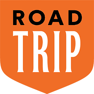 Orange badge with Road Trip written in black and white