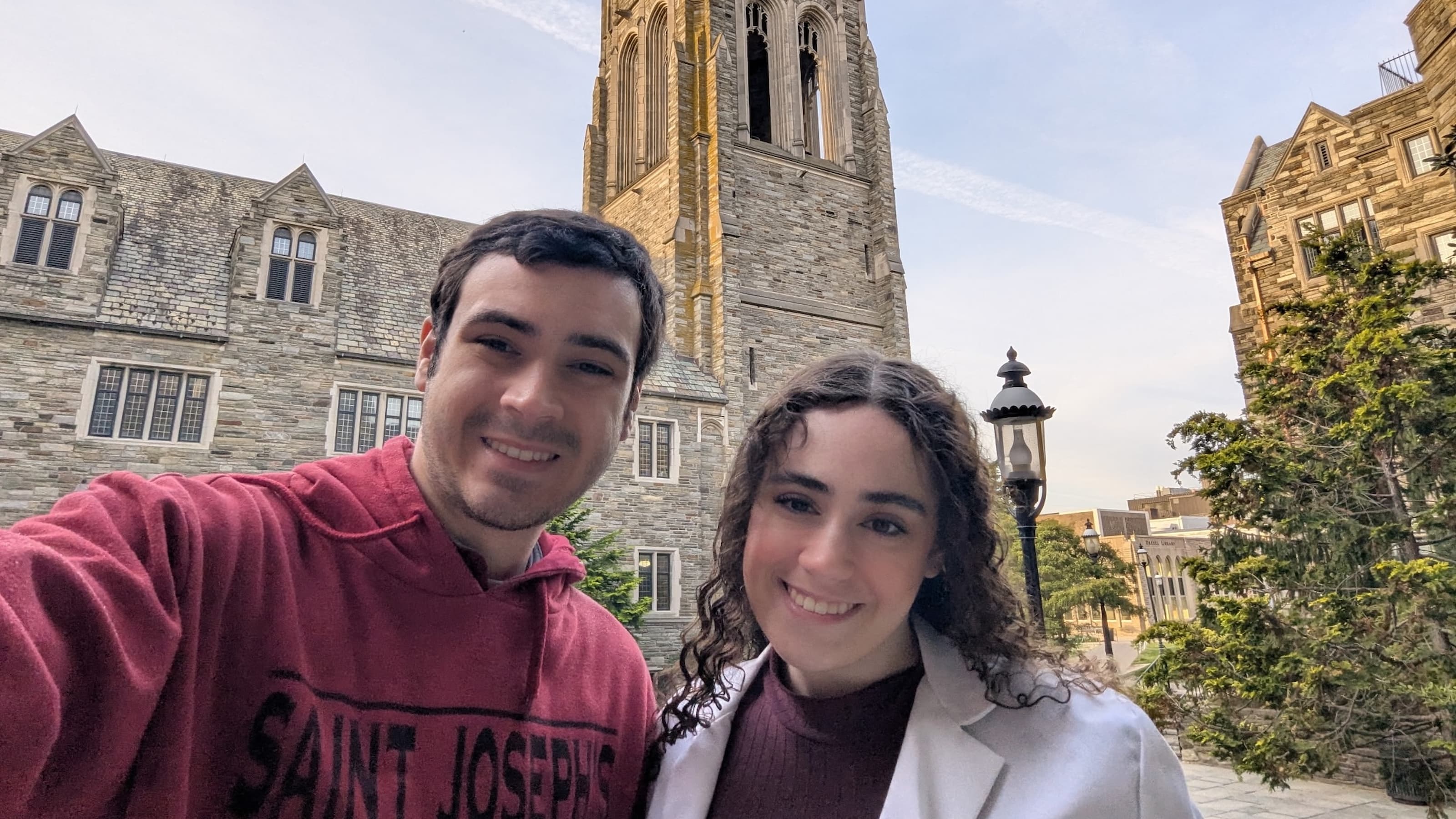 Marguerite Danker, BS ’23, PharmD ’25, and Walter Danker, BS ’25, smile in front of Barbelin Hall.