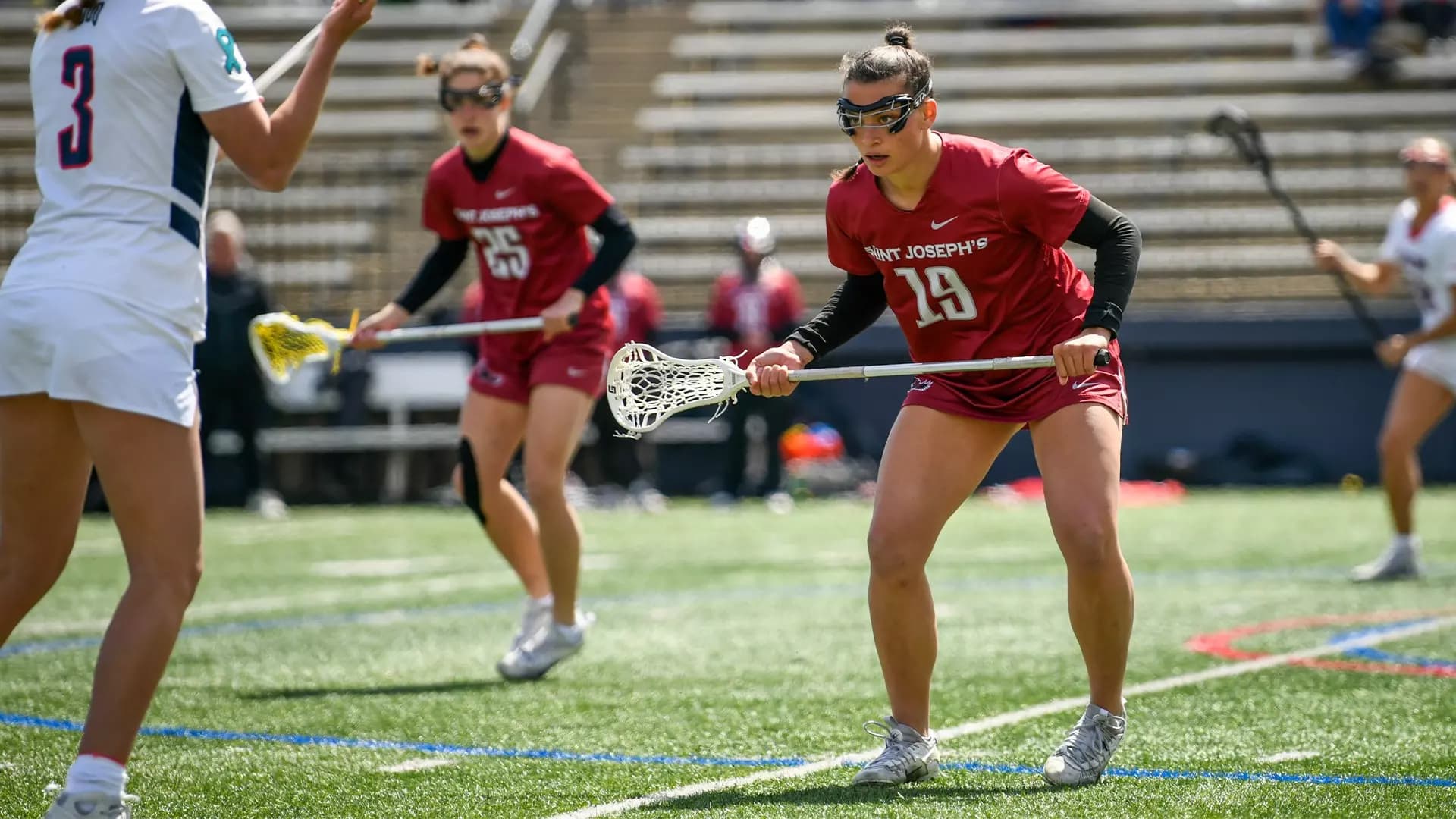 Female Saint Joseph's University lacrosse player on the field 