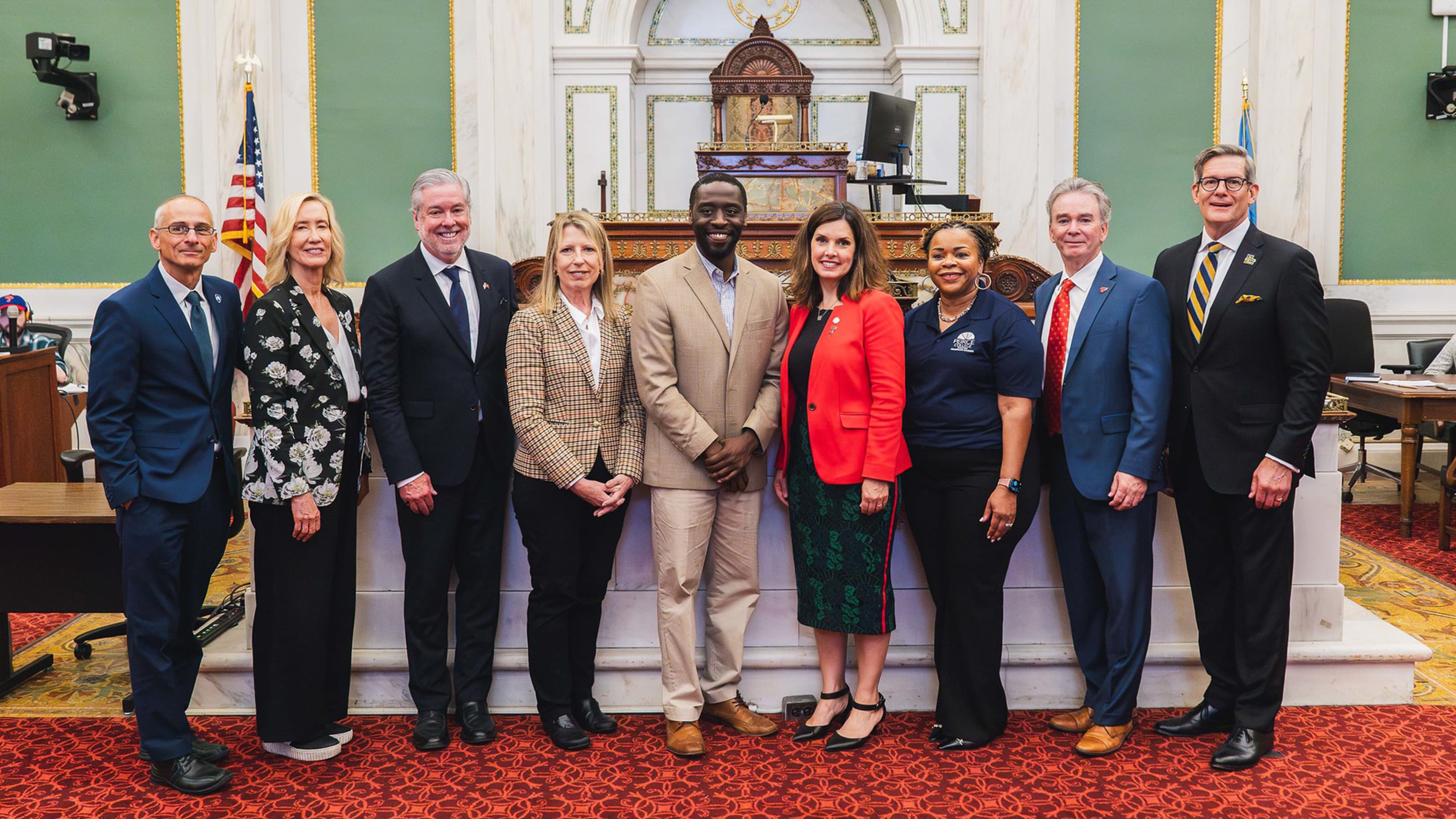 Nine members of the Higher Academia Intergovernmental Task Force posed in Philadelphia's City Hall