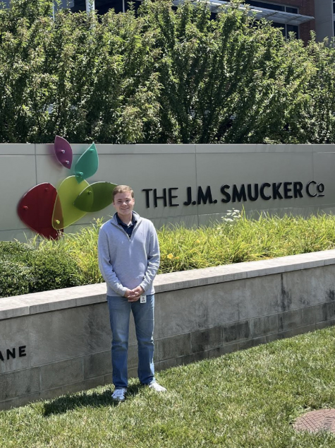 Jacob MacPherson standing outside of the J.M. Smucker Co. building
