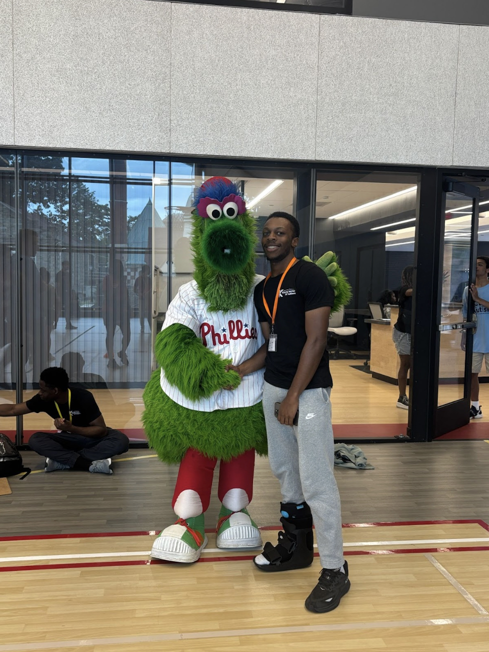 Edward standing with the Phillies Phanatic on Saint Joseph's basketball court