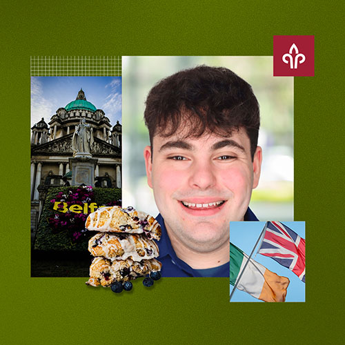 A man smiling with crumpets and flags next to him