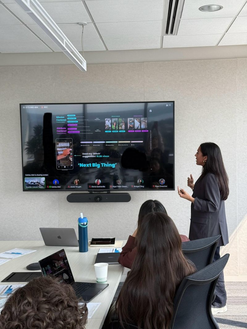Eshika turned toward a television screen giving a presentation