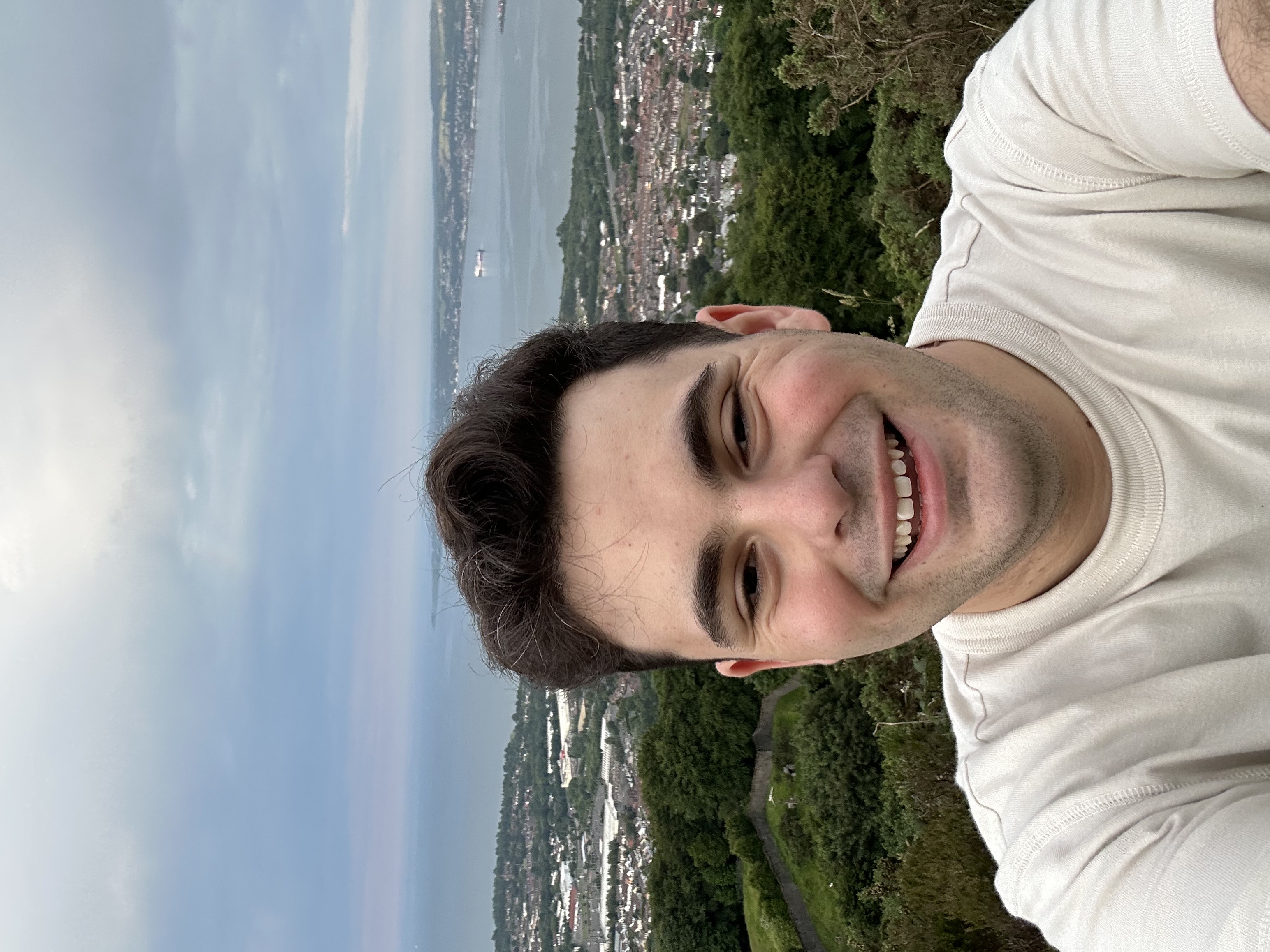 A selfie of Jake in front of a body of water