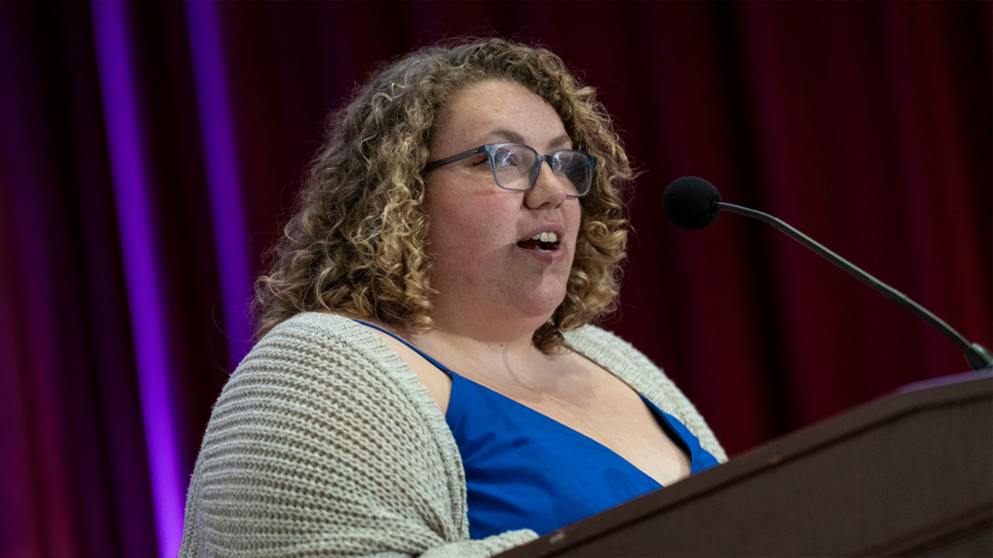 Maddie Marriott speaking at a podium
