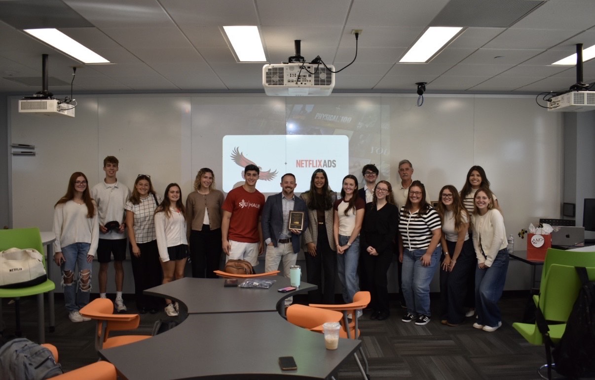 Steve Dorn, BS ’11, poses with the student members of the American Marketing Association