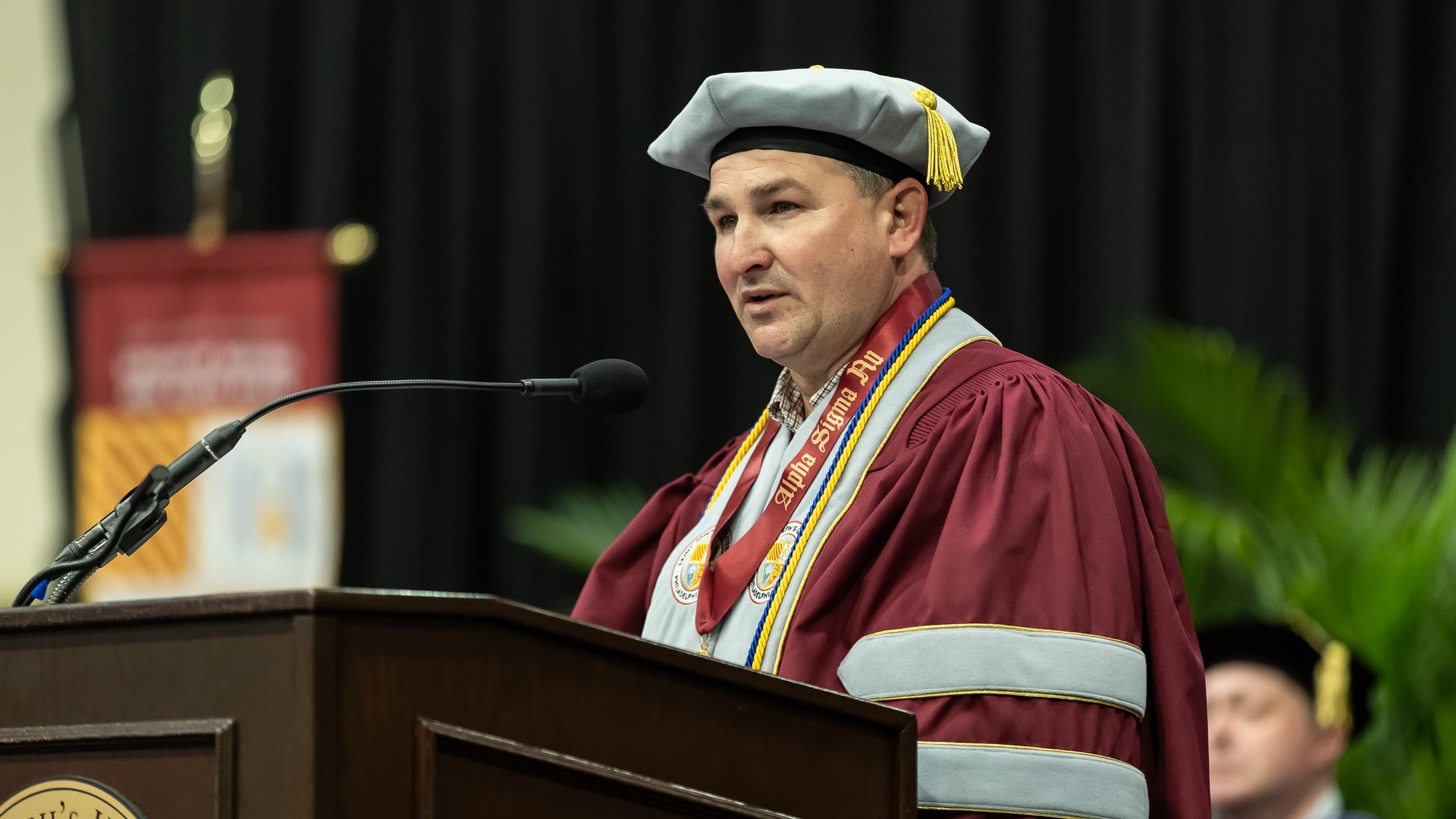 Doctoral student speaker Thomas Every at the podium