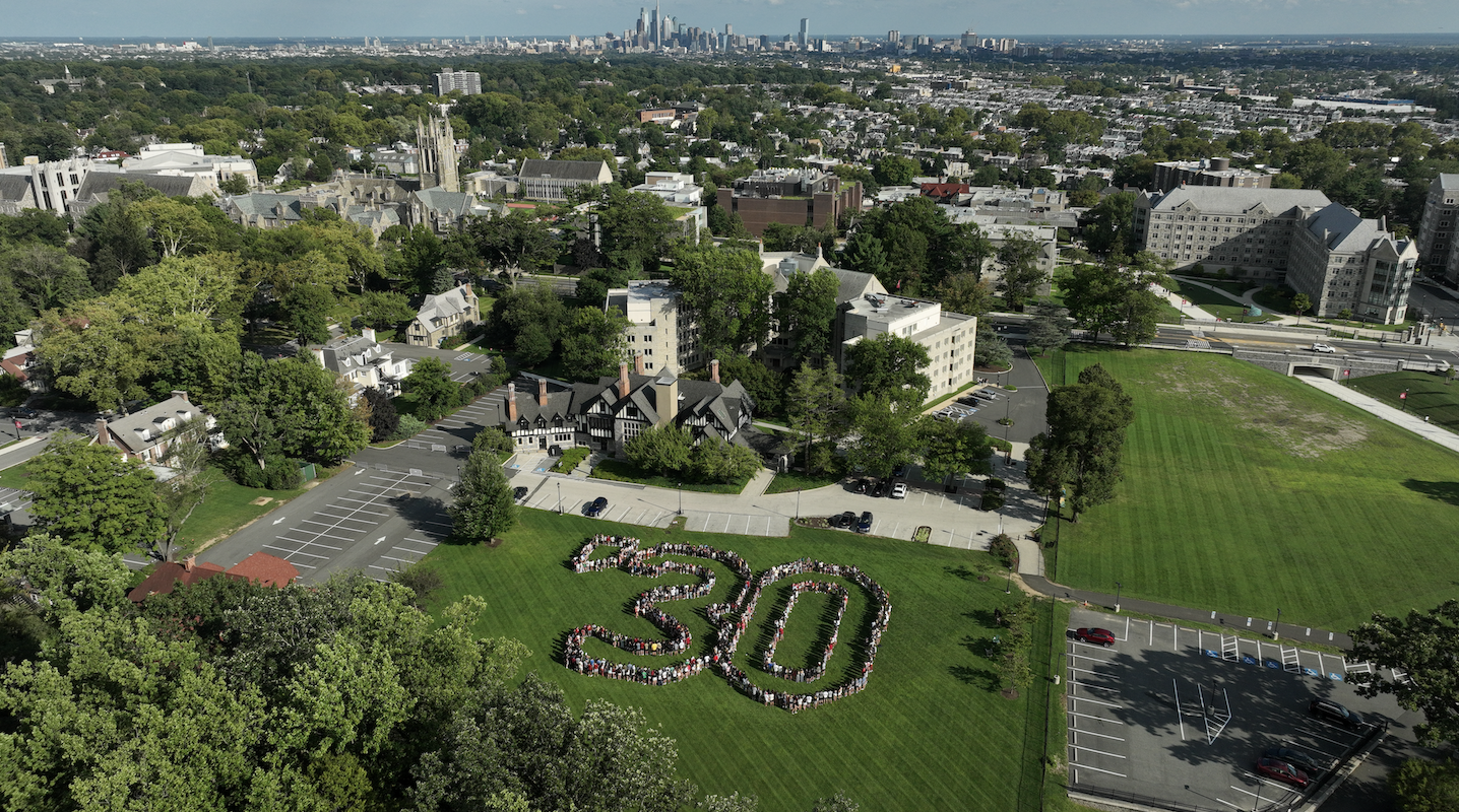 Aerial shot of the Class of 2030 with the city skyline in the back. 