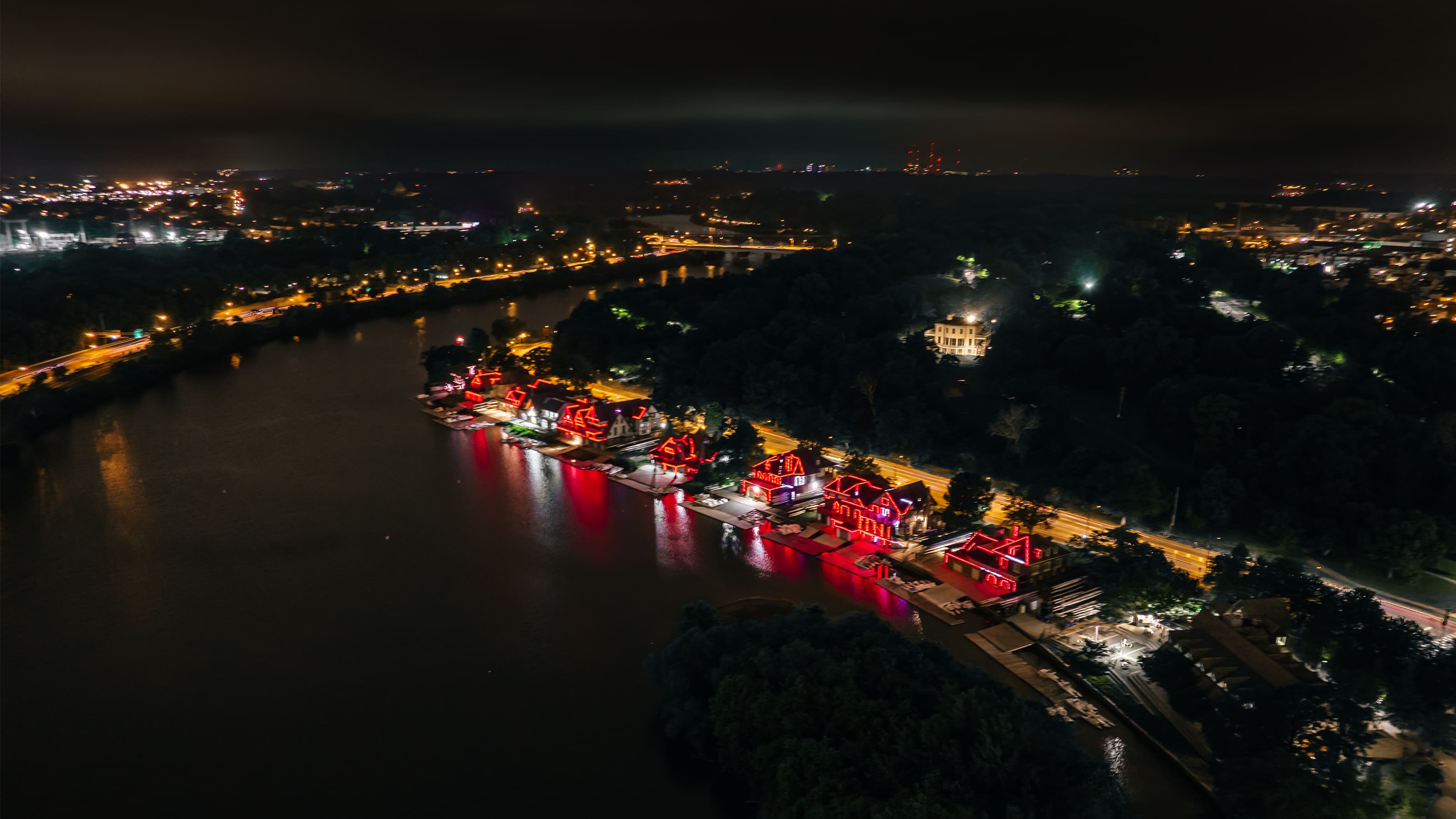 Boathouse row lit up in red