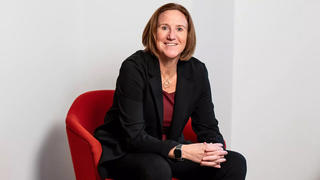 Jill Bodensteiner sitting on red chair