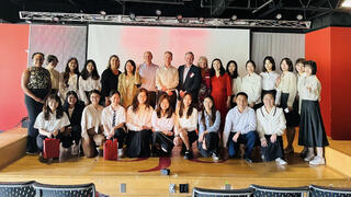 Students from the SJU-HNNU joint master’s program in group gathering on stage